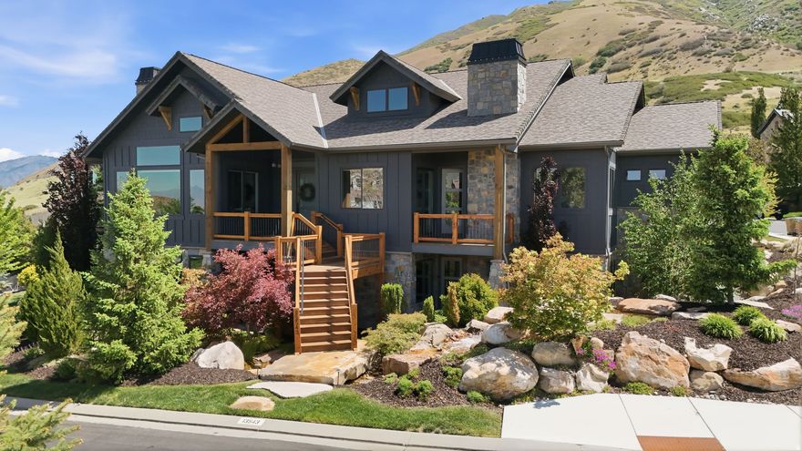 Positioned within the highly sought after Steeplechase community, this stunning former Parade Home offers refined living surrounded by sweeping mountain and valley views. Designed for both elegance and comfort in mind, the home showcases impressive architectural details, expansive windows and beautifully curated living spaces filled with natural light. The main living area features soaring ceilings and dramatic wall of windows that highlight the surrounding scenery. A spacious gourmet kitchen anchors the home, complete with custom cabinetry, large island and high end finishes create a space that is both functional and elegant. The primary suit provides a peaceful escape, offering generous space, oversized windows, fireplace and a beautifully designed spa inspired ensuite bath featuring dual vanities, soaking tub, an oversized shower and large walk in closet. The lower level is designed for entertaining with a second kitchen, family room, expansive theatre room and a dedicated gym. Step outside to a covered patio featuring an outdoor fireplace & outdoor kitchen, creating an inviting space to gather while taking in the sweeping mountain views and surrounding natural beauty. Offering a rare combination of design, comfort and breathtaking scenery, this exceptional property presents an opportunity to experience elevated living in one of the areas more desirable neighborhoods.