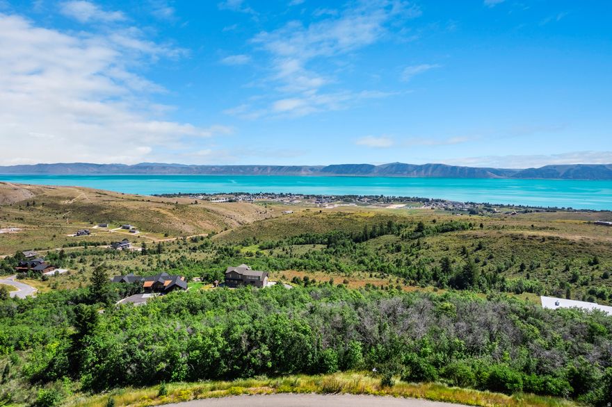 Beautiful 1-acre, tree-covered lot offering incredible views of Bear Lake and is located in the highly desirable Eagle Feather area of Shundahai. With short-term rentals permitted and paved roads for easy, year-round access, it's the perfect place to build your dream mountain retreat or a high-performing vacation rental. Nestled among mature trees, the lot provides privacy and a peaceful mountain setting-with just enough clearing to showcase the breathtaking blue waters of Bear Lake. Whether you're soaking in the views or exploring the outdoors, this property offers the best of both worlds. Just 7 minutes to the lake and marina, and only 15 minutes from Beaver Mountain Ski Lodge. Plus, with direct access to hundreds of miles of nearby mountain trails, you can ride or hike straight from your doorstep-no trailer required. Power and water are already stubbed to the lot, making it easy to start planning and building. Whether it's adventure, relaxation, or income potential you're after-this lot has it all.