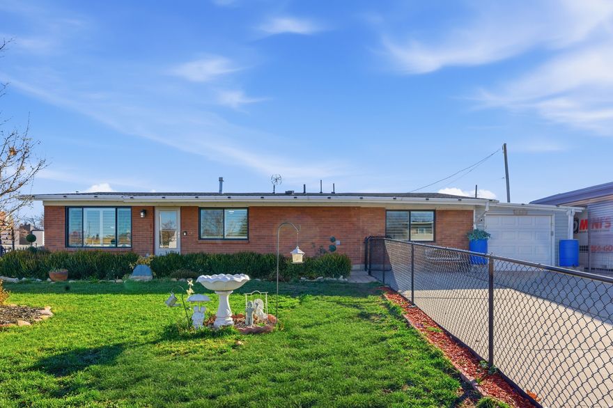 Welcome home. This beautifully loved single-level gem was cared for with pride in every detail. Featuring 4 bedrooms, 2 bathrooms, and two family rooms, plus 30 paid-off solar panels. The kitchen was thoughtfully remodeled with gorgeous cabinets, hardware, and real tile backsplash. Bathrooms upgraded with custom finishes and glass shower doors. Fully gated with covered RV parking, tandem garage, room for 6 cars, fruit trees, vegetable garden, gazebo, shed, and cameras included. No stairs, no shortcuts, just a home the sellers truly hope you'll love as much as they have. Minutes from I-215, Bangerter Highway, shopping, schools, and more.   The first mortgage has an approximate balance of 274,149.06 with a low 2.875% interest rate. The second mortgage has an approximate balance of 102,166.90 with an 8.5% interest rate. Assumable financing can provide qualified buyers with potential monthly savings compared to current market rates. Buyer to verify loan terms, qualifications, and assumption requirements directly with the lender.