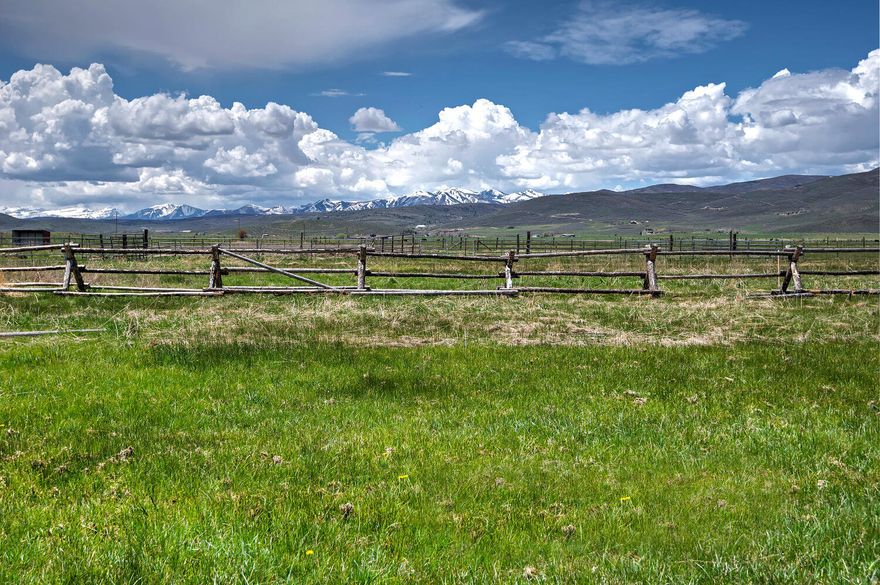 Discover the ultimate opportunity at 240 W Simpson Lane in Kamas. This stunning, flat, buildable lot can be subdivided into two lots with the ability for two homes and two guest homes, giving you flexibility for multi-generational living, income potential, or a private compound. Design your dream setup with a main home, guest house, barn, and outbuildings for your four-legged friends, all on a serene piece of land that already has electrical infrastructure in place and has been perk tested.  You are just minutes from Old Town Park City, Deer Valley, and world-class ski areas, so you can enjoy mountain town living without sacrificing convenience. Spend your days exploring nearly 20 miles of trails at nearby High Star Ranch, or head into the Uinta Mountains for snowshoeing, hunting, fishing, and endless outdoor adventure. Enjoy live events and dining at the DeJoria Center, watch wildlife at the Kamas Lagoons, and benefit from green belt tax status with existing hay fields. Contiguous to deeded open space, this peaceful property feels private and open, with room to grow and endless possibilities for the next owner.