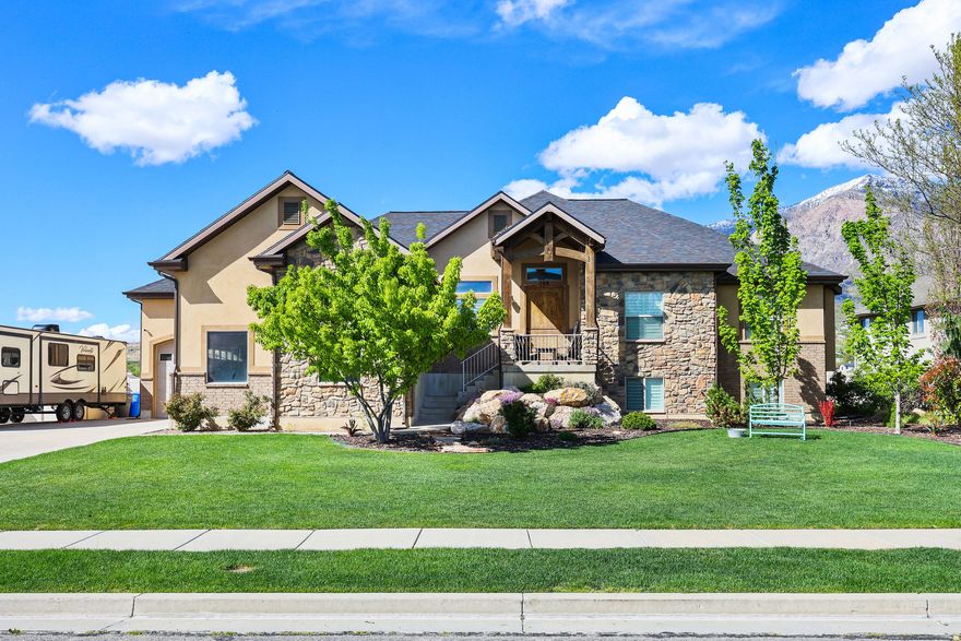 Welcome to your dream home in Pleasant View-where stunning curb appeal, comfort, and breathtaking mountain views come together in one exceptional, move-in-ready property. From the moment you arrive, you'll notice the pride of ownership and inviting atmosphere that carries throughout-enhanced by recent upgrades including a new roof, updated flooring, modern fixtures, stylish lighting, a new water heater, and refreshed landscaping.  Step inside to a bright, open great room featuring soaring inverted vault ceilings, abundant natural light, and a cozy fireplace-perfect for both relaxing evenings and entertaining guests. The updated kitchen shines with new countertops, modern appliances, and a functional layout that seamlessly connects to the main living space.  Offering 5 spacious bedrooms and 3 well-appointed bathrooms, this home provides plenty of room to live, work, and unwind. The fully finished basement is packed with extras, including a dedicated theater room ideal for movie nights, along with a custom-built secure room concealed behind a vault-style door.  Out back, enjoy one of the home's most impressive features-unobstructed mountain views with no backyard neighbors. Host gatherings on the covered Trex deck, or relax around the firepit in the spacious yard below. A climate-controlled storage shed adds versatility for hobbies, workspace, or additional storage.  Don't miss the epoxy-coated garage floors that add both durability and a clean, polished look to the oversized garage space.  With space, upgrades, privacy, and views, this home truly checks all the boxes. Schedule your private showing today!