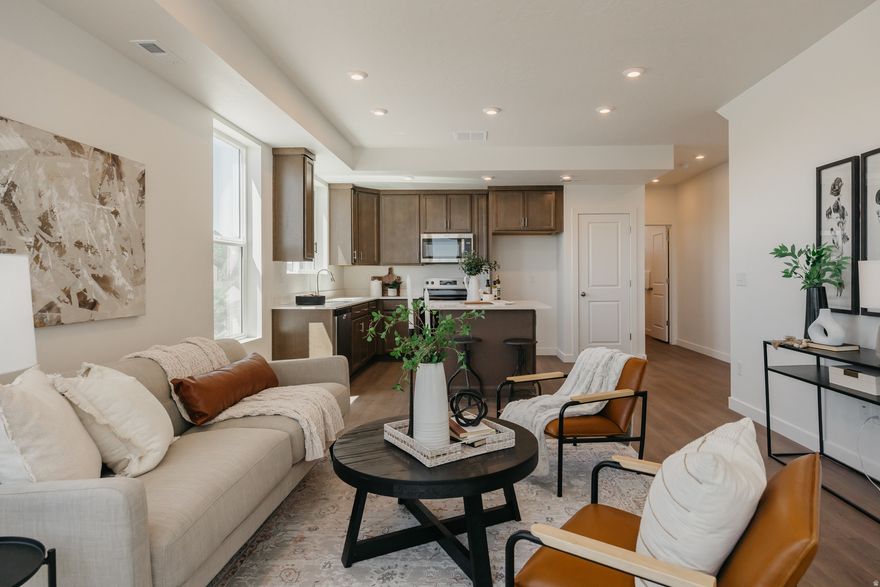 MODEL HOME OPPORTUNITY! Qualifies for First-Time Homebuyer Assistance Program (SB 240)! Step into luxury with this brand-new, never-lived-in model home featuring The Seneca floorplan in the highly sought-after Prominence Point community by Fieldstone Homes-located in beautiful North Ogden, known for its mountain views, outdoor lifestyle, and small-town charm. This stunning 3-bed, 3-bath, 3-story townhome was designed to impress, showcasing an open and airy main living level with a bright, modern kitchen flowing seamlessly into the family room. Large north-facing windows frame picture-perfect views and fill the space with natural light. You'll also love the extra-wide single-car garage, offering added storage and everyday convenience. Retreat to the top-floor owner's suite, where you'll find a spacious bedroom, private bath, and generous walk-in closet-your own peaceful escape. Each bedroom has its own full bathroom, making this layout ideal for multiple scenarios. Located in North Ogden, Prominence Point puts you minutes from scenic trails, parks, and outdoor recreation-while still offering easy access to shopping, dining, and commuter routes. This is a rare chance to own a model home with designer finishes in one of Weber County's most desirable locations. Model homes don't last - don't miss this opportunity!