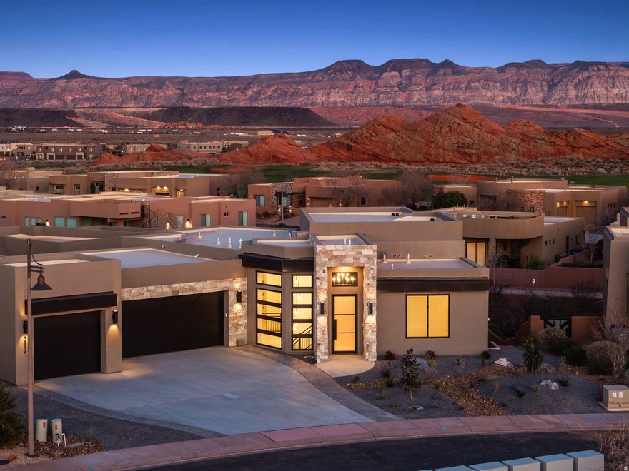 Experience elevated desert living in this stunning new construction home, perfectly positioned on one of Southern Utah's most sought-after golf courses. Spanning over 4,000 square feet, this 4-bedroom, 4-bath residence seamlessly blends modern luxury with breathtaking natural surroundings.  Designed for both comfort and entertaining, the home features a spacious walkout basement complete with a kitchenette--ideal for guests, multi-generational living, or a private retreat. Upstairs, an expansive deck captures sweeping views of Southern Utah's iconic red rock landscapes, creating the perfect setting for sunrise mornings and unforgettable evenings.  The outdoor space is equally impressive, highlighted by a private pool that offers a resort-style escape right in your backyard. A rare combination of functionality and luxury continues with a dedicated boat garage, providing ample space for all your toys, convenient since you are 5 minutes from Sand Hollow.