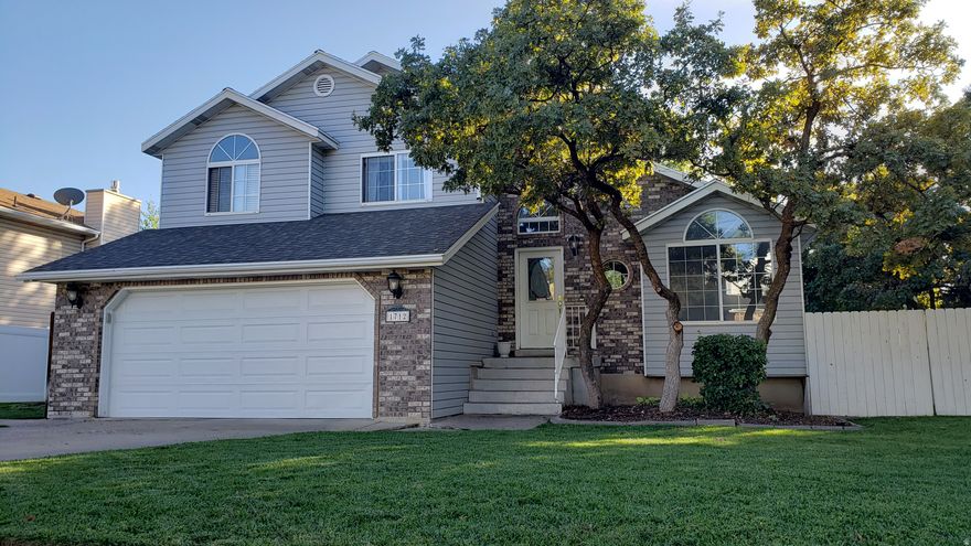 This beautiful home was one of the last in the area built with solid lumber construction-no particleboard beams and no bouncy floors-providing lasting quality you can feel. Enjoy vaulted ceilings, an open layout, and fantastic natural light year-round. The main level offers both a living room and family room, with an additional large bonus family room in the basement. You'll also love the very large storage room downstairs for all your extra needs. Step onto the walk-out deck and take in the close-up mountain views. The backyard is perfect for entertaining, complete with mature trees, lush grass, and beautiful landscaping. A built-in barbecue gas line makes outdoor gatherings easy. Upgrades & Features You'll Love: Utopia Fiber, New water heater (2021) New roof (2017)Water softener North-facing home with incredible natural light Located just 3 minutes from Hill Air Force Base and 20 minutes from Salt Lake City, this home sits in a peaceful, tree-lined neighborhood close to restaurants, schools, and shopping-all within walking distance. A rare combination of quality construction, comfort, and convenience-ready for its next owner.