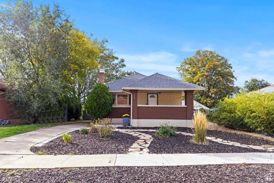 Historic Rambler/Cottage with 3 bedrooms, 2 bathrooms, RV pad. NO HOA. New High Efficiency furnace and Central Air/AC in 2019. NEW tankless water heater. Main level laundry. Front Load SS Washer/Dryer INCLUDED. SS Refrigerator INCLUDED. Larger kitchen with dishwasher. All SS appliances included. HUGE primary suite. Basement entrance. Huge 650 square feet of dugout storage space in basement. Low maintenance xeriscaped yard. Smart thermostat and Ring doorbell. Newer LVP. Double paned vinyl windows. Private yard surrounded by mature trees provides year round shade. Complete main sewer line and main water line professionally replaced 2019. Updated electrical w/new meter & service. Foundation reinforced 2024. Architectural roof 12-13 yrs old. Newer LVP flooring. All plumbing updated to pex.**MINUTES FROM DOWNTOWN OGDEN**. Close to Ogden River Parkway hiking/walking/biking trails. Close to Frontrunner, Megaplex Theatre, EOS Gym, climbing gym, Flowrider, Historic 25th Street shopping, dining, entertainment, Farmer's Market and so much more!! One Year Equity Home Warranty INCLUDED.