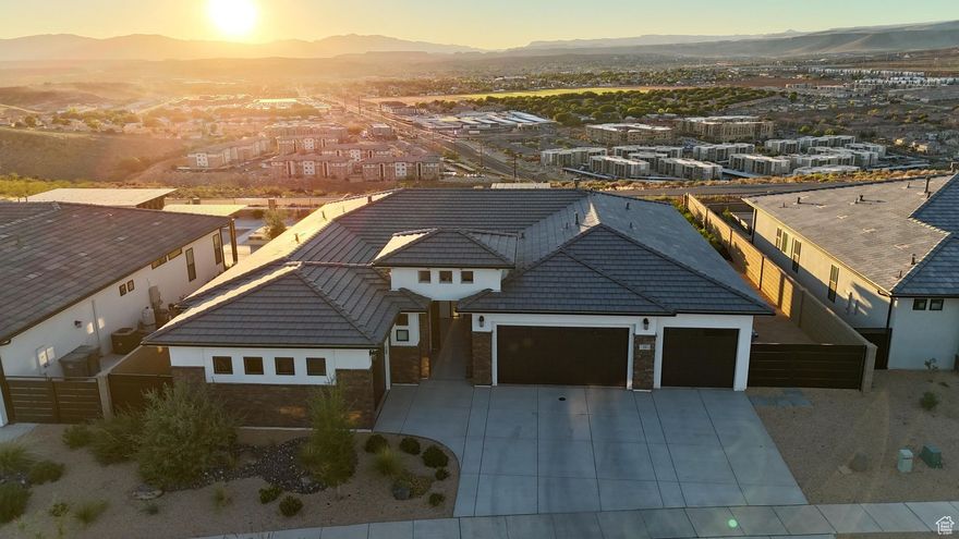 This luxury home showcases panoramic views of the valley and Pine Valley Mountain. With 5 spacious bedroom sand 4.5 baths, the open concept layout is filled with natural light and designed for both comfort and sophistication. Exceptional craftsmanship throughout! The living room features a stunning fireplace and large sliding doors that seamlessly blend indoor and outdoor living. The gourmet kitchen is equipped with top of the line appliances, large island quartz countertops and custom cabinetry. The generous primary suite includes a spa inspired ensuite bath. Outside, the pristine backyard offers multiple awnings, low maintenance turf and a 9 person hot tub overlooking the valley. Additional highlights include a 4 car garage and direct access to the nearby bike trails