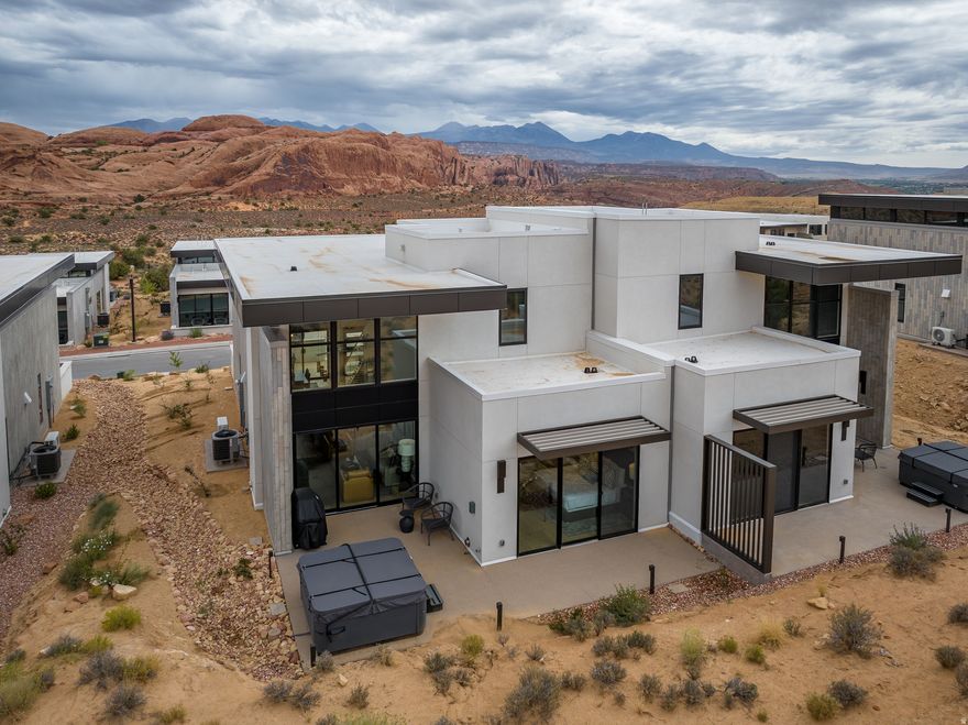 LIONSBACK RESORT  An unparalleled experience of discovery and respite. Designed to blend in with its natural landscape, Lionsback Resort offers an unrivaled launchpad for all the adventure, exploration and relaxation Moab has to offer, all while treading lightly on the land. While its 175 acres of land with 70% open space offer a sense of seclusion, Lionsback Resort is a stone's throw away from the City of Moab, so you're never far from community and culture. This timeless 2-story Strata Casita meets sophisticated design, immersing you in the surrounding desert landscape with both indoor and outdoor living. An abundance of large windows with vaulted ceilings gives you the unobstructed views of sunlight reflecting off red rock fins and the sunset alpenglow on the La Sal Mountains. Earthy desert hues from the Fireclay tile backsplash and Italian cabinets are beautifully offset by clean, modern lines from the timeless quartz countertops. Thoughtful design represents the surrounding terrain, all while incorporating high-end finishes, from Wolf and Subzero appliances to a 5-piece spa-like bathroom with wet room, soaking tub and Waterworks plumbing fixtures, to the built-in speaker system with Sonos amp. Offering 2 en suite bathrooms, this luxury home has short-term rental zoning and comes fully furnished and accessorized, including linens, decor, dishware, kitchen wares, televisions, and hot tub. When the wild terrain is calling, Lionsback Resort offers on-site access to the Mill Creek Trail and Hells Revenge 4x4 trail, standing at the gateway of the world-renowned Sand Flats Recreation Area, home of the famous Slickrock Trail, two National Parks, Arches and Canyonlands, and the Colorado River for limitless discovery.