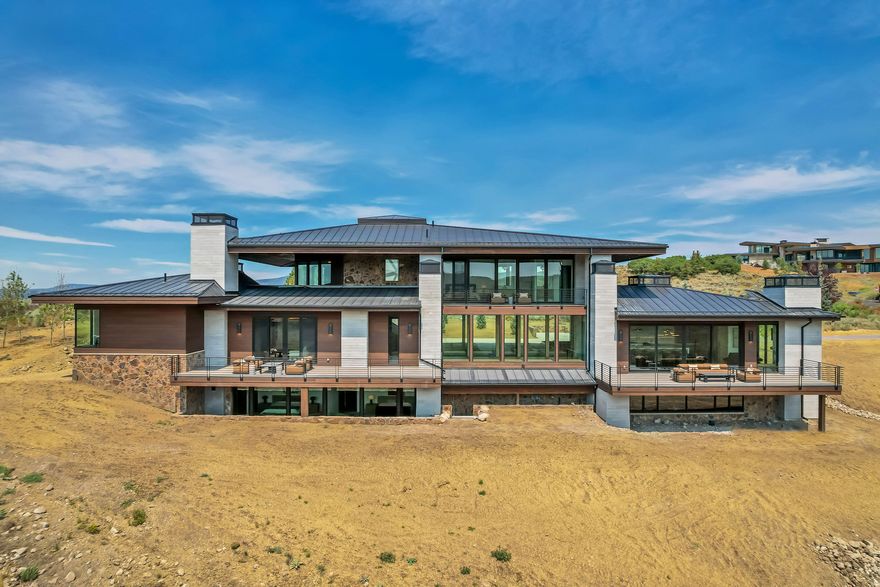 Welcome to this luxurious turn-key 2-story modern-organic home, nestled in the exclusive, Painted Shores community within the gates at Promontory. Situated on a 1.27-acre lot, this stunning 6-bedroom, 8-bathroom residence offers 9,206 sq ft of refined living space. A Golf Membership at Promontory is available to purchase separately, granting full access to Jack Nicklaus' Painted Valley Course, the Pete Dye Canyon Course, and The Hills Par-3 Course, along with dining privileges at the Peak and Sage restaurants. This home blends modern design with natural elements, featuring an open floor plan and abundant natural light. The kitchen and semi-formal dining areas boast a vaulted ceiling and expansive sliding glass door that leads to a balcony deck, perfect for al-fresco dining with a view. Enjoy the convenience of single-level living with a main-level bedroom and attached full bathroom, while additional bedrooms on the upper and basement levels each enjoy easy access to balcony decks for outdoor enjoyment. The main floor also features a detached Casita perfect for a studio, guest living quarters, or private office. The Primary Suite is tucked away and offers the ultimate retreat, complete with a stand-alone soaker tub, steam shower, and private balcony deck, ideal for relaxation. The property also includes an oversized storage room in the basement for all your ski gear and other essentials, as well as an expansive courtyard entry that creates a welcoming atmosphere. Attached to the home is a 3-car garage to store your toys and vehicles, complete with 220V EV Charger Hookups, while additional uncovered designated parking for 5 additional vehicles is hosted in the driveway. The Painted Shores HOA offers access to a vast trail system for hiking, biking, and outdoor recreation, along with Nordic Ski Tracks and a Tubing Hill during winter. This home invites you to enjoy both luxury and the great outdoors and is one that you won't want to miss out on. Reach out for more details today! Buyer/Buyer's Agent to verify all.