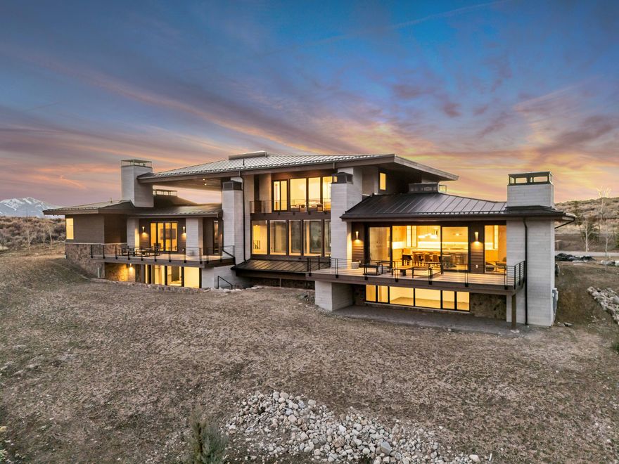 Welcome to this luxurious turn-key 2-story modern-organic home, nestled in the exclusive, Painted Shores community within the gates at Promontory. Situated on a 1.27-acre lot, this stunning 6-bedroom, 8-bathroom residence offers 9,206 sq ft of refined living space. A Golf Membership at Promontory is available to purchase separately, granting full access to Jack Nicklaus' Painted Valley Course, the Pete Dye Canyon Course, and The Hills Par-3 Course, along with dining privileges at the Peak and Sage restaurants. This home blends modern design with natural elements, featuring an open floor plan and abundant natural light. The kitchen and semi-formal dining areas boast a vaulted ceiling and expansive sliding glass door that leads to a balcony deck, perfect for al-fresco dining with a view. Enjoy the convenience of single-level living with a main-level bedroom and attached full bathroom, while additional bedrooms on the upper and basement levels each enjoy easy access to balcony decks for outdoor enjoyment. The main floor also features a detached Casita perfect for a studio, guest living quarters, or private office. The Primary Suite is tucked away and offers the ultimate retreat, complete with a stand-alone soaker tub, steam shower, and private balcony deck, ideal for relaxation. The property also includes an oversized storage room in the basement for all your ski gear and other essentials, as well as an expansive courtyard entry that creates a welcoming atmosphere. Attached to the home is a 3-car garage to store your toys and vehicles, complete with 220V EV Charger Hookups, while additional uncovered designated parking for 5 additional vehicles is hosted in the driveway. The Painted Shores HOA offers access to a vast trail system for hiking, biking, and outdoor recreation, along with Nordic Ski Tracks and a Tubing Hill during winter. This home invites you to enjoy both luxury and the great outdoors and is one that you won't want to miss out on. Reach out for more details today! Buyer/Buyer's Agent to verify all.