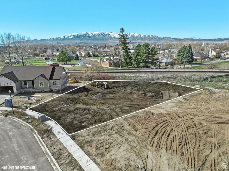 No HOA or CC&R's! Utilities are stubbed to the lot line. Prime Old Town Lehi Lot that have plans and engineer stamps all ready to build your dream home if you like the plans or create your own! Seize this rare opportunity to own a 1/3-acre lot in the heart of a quiet, secluded neighborhood-where peaceful living meets unbeatable convenience. Home across the street just sold for $1.2 million. Just minutes from shopping centers, Lehi Main Street, and freeway access, this lot is primed and ready for your vision. Current plans boast a stunning 6-bedroom, 5-bathroom home. Main level includes 3 bedrooms, 2 bathrooms. The primary suite is located on the opposite side of the home and from the other bedrooms for privacy. Laundry room, kitchen, living and bonus room for office on main level. Main level 2,229 sq ft. Private stairs leading to basement in the home and an exterior entrance as well. Spacious basement Layout: Features a large basement mother-in-law suite with exterior entrance, perfect for multi-generational living or rental income with approval from city. Basement includes 3 bedrooms, each with their own bathroom, full kitchen, dining room, game room, living room, laundry room and cold storage. Basement is 2,365 sq ft. Three-Car Garage for ample storage and convenience. Garage is 969 sq ft. This deal won't last long! Lot is prepped for building: recently cleared of large weeds, almost ready for your contractor to break ground. Why This Lot? This isn't just any land-it's a head start on an incredible future home. Build a masterpiece tailored to your taste. The lot's size and thoughtful design offer flexibility and value that's hard to find in today's market. Nestled in a serene, small community, this lot offers tranquility without sacrificing proximity to Lehi's vibrant amenities. Picture your family thriving in a custom-built home, surrounded by the charm of Old Town Lehi, with top schools, shopping, dining, and entertainment just a short distance away. Don't miss out on this unique opportunity. Note; ariel photos were taken before homes next door were completed. Buyer to verify all information.