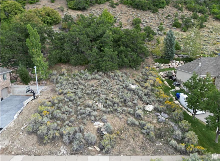 Welcome to your dream homesite on the prestigious Bountiful bench! This .66-acre lot offers a rare opportunity to build your custom sanctuary with sweeping views of the valley and lake below. Enjoy stunning sunrises and sunsets from this elevated perch while still being just minutes from local amenities, schools, and downtown Bountiful. Utilities are stubbed to the lot for added convenience, making your build process that much easier. Come experience the perfect blend of tranquility, accessibility, and natural beauty. Acreage figure is provided as a courtesy estimate only and obtained from county records; buyer is advised to obtain an independent measurement.