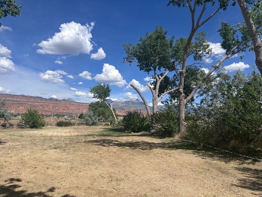 Discover the perfect blend of space, scenery, and investment potential just a short drive from Moab, Arches National Park, and Canyonlands. This 2.5-acre property in San Juan County offers a rare opportunity to own a short-termrentable retreat in one of Utah's most sought-after outdoor destinations. With four RV pads and a 4 bedroom, 4 bath home, 2,136 sq ft, designed for hosting groups and families, the layout is ideal for maximizing rental income or creating a private basecamp for your own desert adventures. Enjoy wide-open skies, peaceful surroundings, and unbeatable access to world-class hiking, biking, river trips, and off-roading, all while generating income when you're not here. A truly versatile getaway with exceptional potential. In addition to the subject property, the adjacent 3.99 acre parcel includes a 500 sq ft Office/Laundry/Shower Building and 9-RV hook ups onsite total, offering strong potential for project expansion or phased development. MLS #2100590