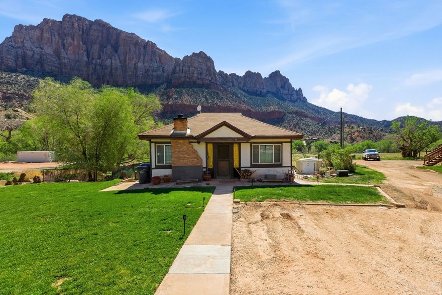 COMMERCIAL PROPERTY I MILE FROM ZION NATIONAL PARK ENTRANCE. This little cottage sits on .51 acre on Zion Park Blvd in Springdale, UT. It was owned by the first Superintendent of Zion and has remained in the family. This is one of the last residential properties remaining in the Central Commercial Zone of Springdale, which allows the highest density development. Complete with power, city water, sewer and 1 share of irrigation water. Don't miss this opportunity to own this coveted piece of commercial property just outside of Zion, where 5 Million visitors pass by every year. Adjacent .41 acre property is also available with a short term rental permit in place.