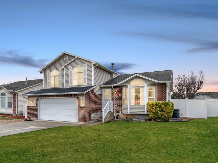 The home you've been waiting for is finally here! Nestled in a fabulous neighborhood within walking distance to the 10-acre James Woodward Park-featuring basketball courts, tennis courts, sand volleyball, playgrounds, and more-this location is hard to beat. Enjoy quick access to Hill Air Force Base and convenient freeway connections for an easy commute.  Step inside to a well-maintained home filled with natural light. The open-concept kitchen and great room create the perfect gathering space, complete with cozy fireplace and durable laminate flooring.  Upstairs offers three generously sized bedrooms, including a spacious primary suite with vaulted ceilings, double closets, and a private en-suite bathroom. Downstairs, a second family room provides additional space for entertaining, relaxing, or hosting guests.  You'll appreciate the abundant storage with a large crawlspace, plus the peace of mind that comes with an updated furnace and central air system.  Outside, fall in love with the fully fenced backyard featuring a large, covered patio-perfect for summer evenings and weekend BBQs. Need space for your toys? The oversized RV parking has you covered.  This one checks all the boxes-don't miss it!