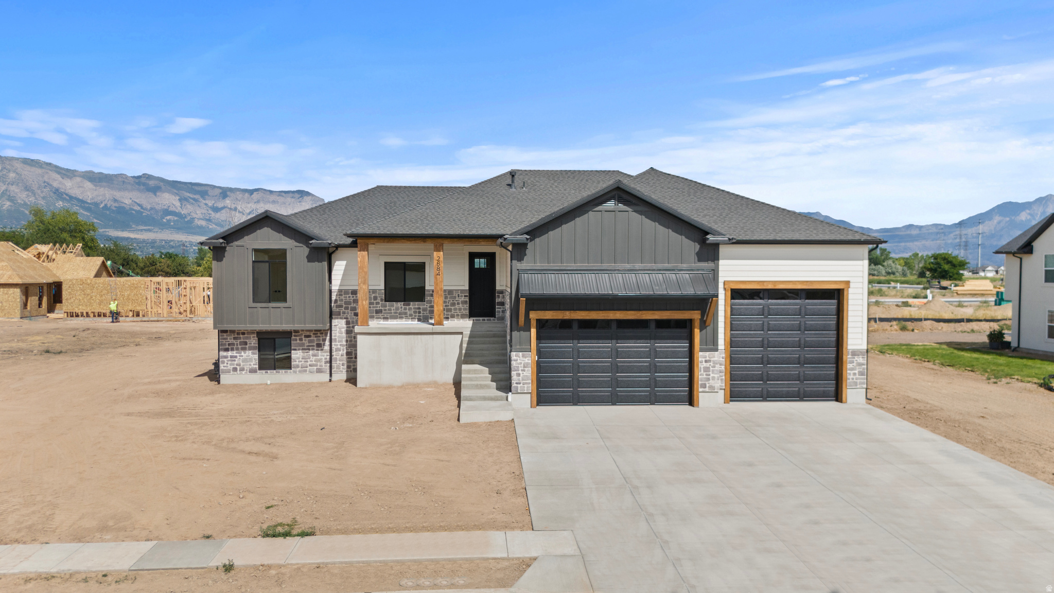 Contemporary exterior featuring a combination of horizontal siding, vertical panels, and stone accents