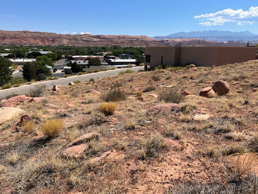 IN TOWN...PANORAMIC VIEWS. Build your dream home on this beautiful elevated 0.49-acre lot nestled in one of Moab's most desirable in-town locations. Perfectly positioned just below Pipe Dream trail, this property offers breathtaking  panoramic views from Arches National Park to Millcreek Canyon. Located at the beginning of a quiet cul-de-sac, you'll enjoy a peaceful setting while still being just a short walk, bike, or cruise away from Moab's dining, shopping, and outdoor attractions.  All utilities are ready to go: municipal water and sewer are available, and power and gas are stubbed to the lot. Opportunities like this are rare, especially in-town lots with this much space, natural beauty, and convenience. Don't miss your chance to make Moab your home!