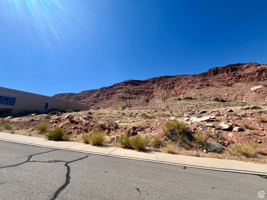 IN TOWN...PANORAMIC VIEWS. Build your dream home on this beautiful elevated 0.49-acre lot nestled in one of Moab's most desirable in-town locations. Perfectly positioned just below Pipe Dream trail, this property offers breathtaking  panoramic views from Arches National Park to Millcreek Canyon. Located at the beginning of a quiet cul-de-sac, you'll enjoy a peaceful setting while still being just a short walk, bike, or cruise away from Moab's dining, shopping, and outdoor attractions.  All utilities are ready to go: municipal water and sewer are available, and power and gas are stubbed to the lot. Opportunities like this are rare, especially in-town lots with this much space, natural beauty, and convenience. Don't miss your chance to make Moab your home!
