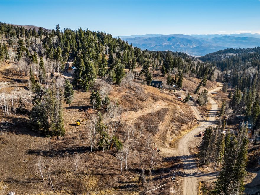 This 1.64-acre south-facing lot in Tollgate Canyon provides beautiful views down the canyon toward the Uinta Mountains, plentiful sunlight, and easy year-round access on a private, maintained plow route. The property is build-ready with a recently passed perc test, utilities at the road, and a partially excavated driveway already in place.  Two potential building sites offer flexibility for your home design. With mature pines and aspens on the property, you'll feel tucked into the trees while still enjoying great sun exposure and open views - something for everyone.  You're just 25 minutes from skiing, mountain biking, Park City's Main Street, and an easy, stoplight-free drive to the new Deer Valley East Village.  A great opportunity to secure a usable, well-positioned homesite in the welcoming community of Tollgate Canyon.  4WD and snow tires/chains are recommended during winter driving.