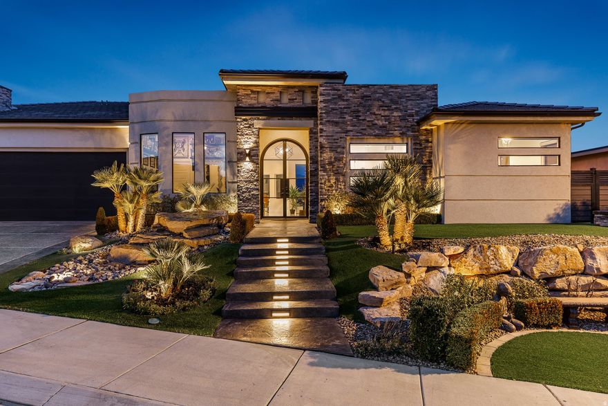 This exquisite luxury residence seamlessly blends contemporary elegance with modern sophistication. Situated above the renowned Sunbrook Golf Course, it offers breathtaking, unobstructed panoramic views of red rock formations, desert landscapes, and majestic mountain horizons. Enter through grand double iron-and-glass doors, accented by designer lighting, into a bright, open main living area. A dramatic 10'  20' disappearing glass wall glides into its hidden pocket, effortlessly merging the great room with the resort-style backyard-creating a true open-air pavilion experience. The chef's gourmet kitchen features premium Caf appliances and sleek quartz countertops, perfect for everyday living and entertaining....