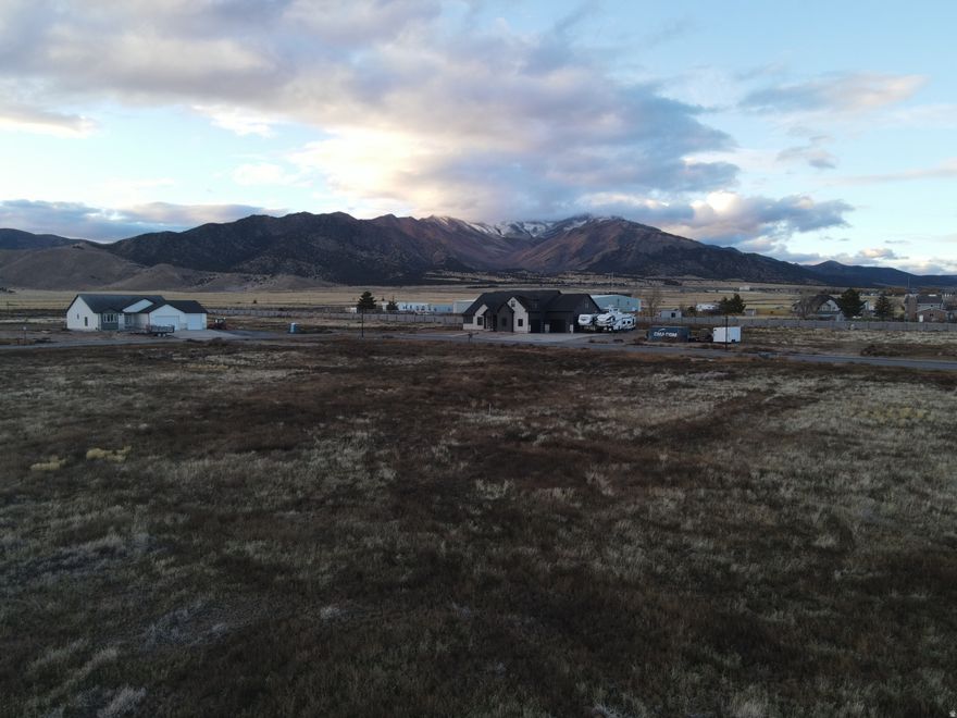 Horse Property with a beautiful view of the Oquirrh Mountains and Cedar Valley. No HOA. This Corner lot offers flexibility for access to all of the property for RV parking, horses or a detached shop. Bring your own builder and build your dream home. Browns Meadow Lot 128. Fiber, Power, and Water are stubbed to the property.