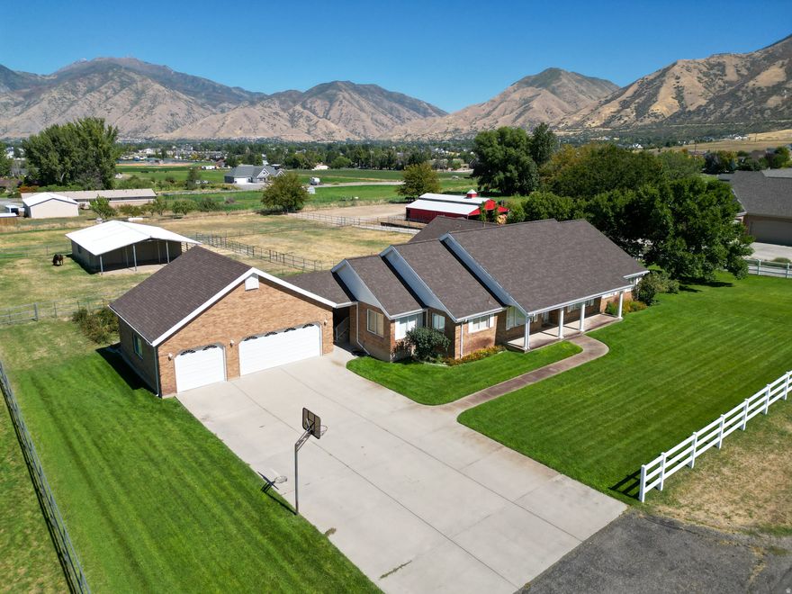 *Be sure to check out the virtual tour & floor plans!* Discover this rare custom all-brick home on over 2 acres of premium horse property in picturesque Mapleton, UT! South-facing with breathtaking Wasatch Mountain views, featuring a large barn, stables, tack room, and corrals. Main-level living with spacious light-filled rooms, formal & informal dining, generous bedrooms, oversized 3-car garage with bonus upper room (game room potential), and expansive garden-perfect for horses and family in a peaceful, trail-rich community! 3.8 shares of Strawberry Water will transfer with a warranty deed. Buyer and Buyers agent to verify all information.