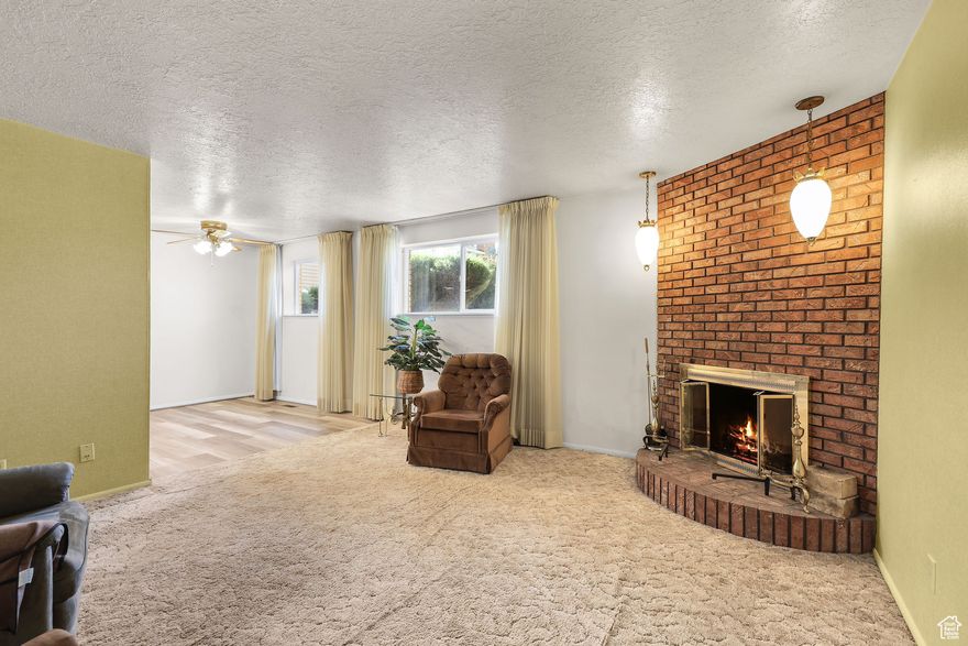 Clean and well-kept condo featuring a brick fireplace, large windows, and updated flooring in the kitchen and dining area. Includes covered parking with private storage, spacious layout, and great natural light. Quiet community with easy access to shops and transit.