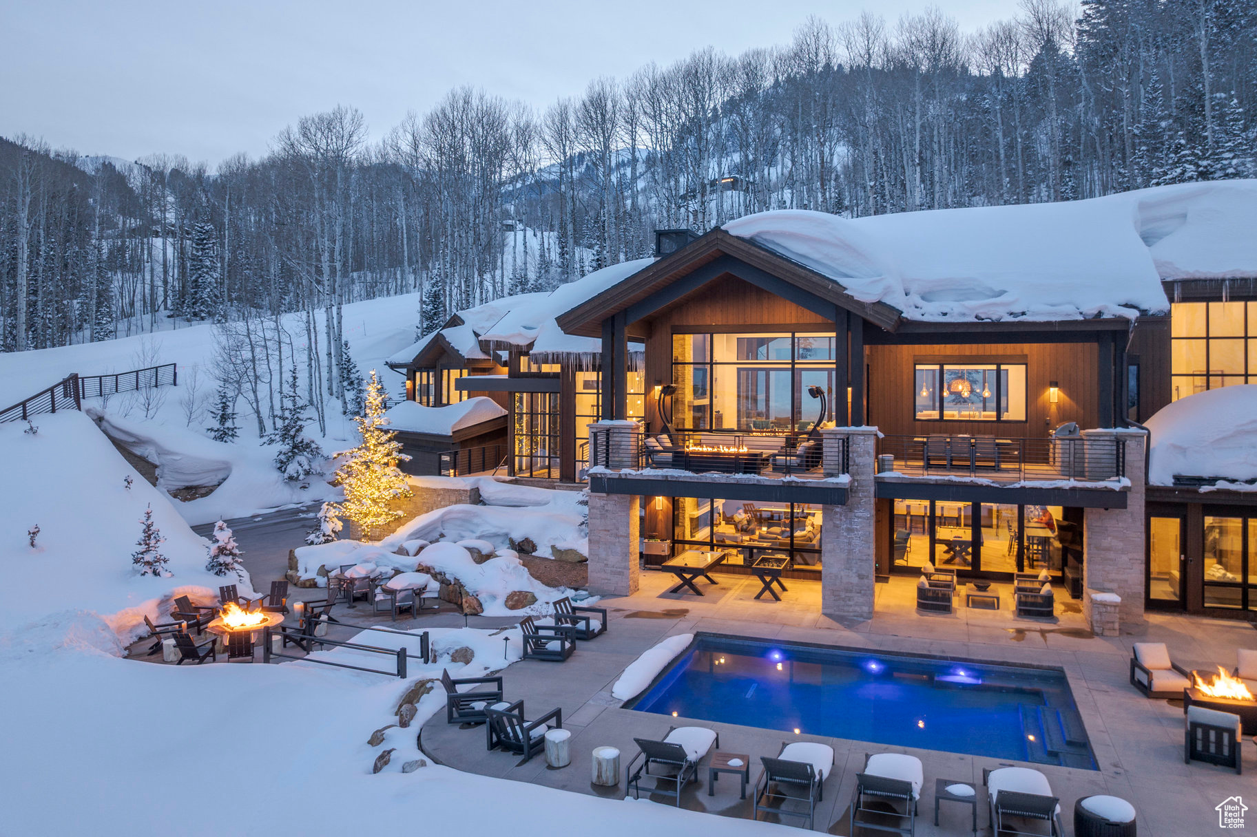 This extraordinary legacy estate presents a once-in-a-lifetime opportunity to own a  coveted slice of skiers' paradise, directly situated on the renowned "Another World" trail.  This private retreat offers unparalleled ski-in/ski-out access at Park City Mountain  Resort, showcasing breathtaking panoramic horizon valley views and exceptional  spaces meticulously designed for both grand entertaining and serene relaxation.  Spanning over 9,000 square feet of exquisitely crafted living space, complemented by  over 4,500 square feet of heated outdoor patio living, this residence is a true four season mountain sanctuary. Highlights include a dedicated entertainment level, a  heated outdoor pool and hot tub, and a rare, separate building envelope across the ski  run, ideal for a private guest house. Step into a world of whimsical escape, where  unparalleled luxury, absolute privacy, and thrilling adventure seamlessly converge.  Arrive in style via a custom tunnel that dramatically unveils this architectural  masterpiece, welcoming you and your guests to a mountain retreat defined by both  adventure and tranquility. Enjoy more time on the slopes with unparalleled ski access,  maximizing precious moments with family and friends. Recent snowmaking  infrastructure upgrades ensure early-season ski access to Tombstone & Iron Mountain,  offering earlier lift access than most of The Colony, and the coveted opportunity for late  afternoon runs before the mountain closes  Summer transforms this haven into a sanctuary of tranquility, where the gentle rustle of  aspen leaves and the soothing sounds of a custom glissading water feature create a  symphony of nature. Direct access to hiking and biking trails from the property further  enhances the allure of this 4-seaons extraordinary family estate.
