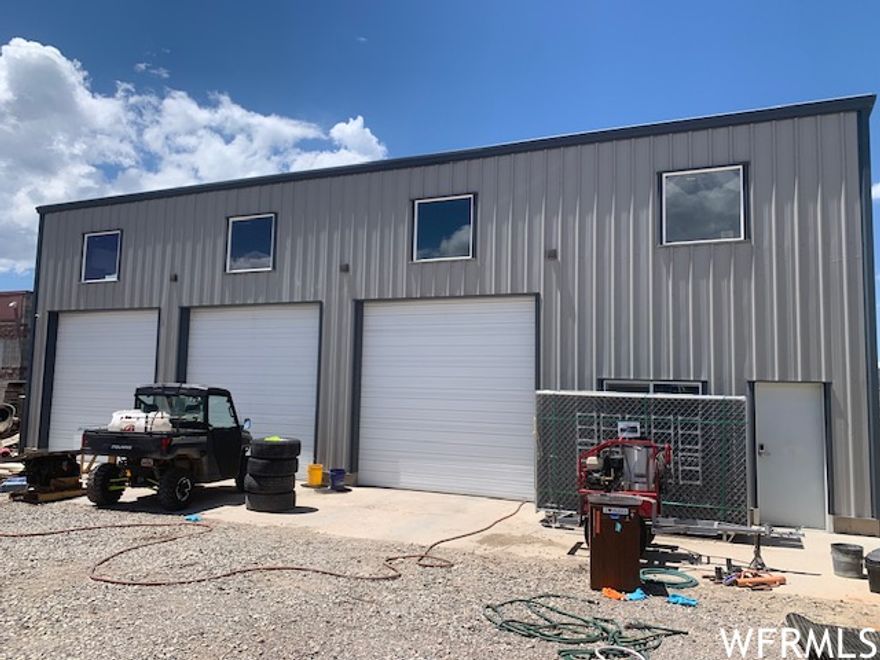 Industrial Shop with offices, conference room and bathrooms. 60' x 60' metal building was built is 2019, is free standing (no columns) 19' tall inside, lots of natural light and has 3 large garage doors on the East side and another large door on the North, all with powered openers. Solar, gas heaters and a wood/coal stove for shop heat. Large office with a customer half bath and an employee half bath then above the office space is a full bath, another office and a conference or break room. Paint storage room with 2 closets. Above is another storage area. Lot is completely fenced with 6' chain link with barbed wire above. Owner taking 4-post lift, compressor and other tools but the 2 post lift and some shelving might be negotiable. Owners have outgrown this property and are build a new shop nearby and desire to lease back for 3 months to finish building and move.