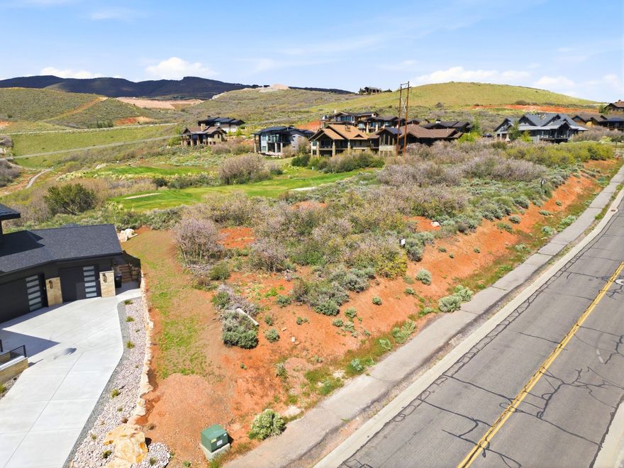 Set high above the Jordanelle in coveted Hideout Canyon, this exceptional homesite captures the kind of views people move to Utah for--sweeping panoramas of Deer Valley, the sparkling Jordanelle Reservoir, and the dramatic ridgeline of Mt. Timpanogos. Preliminary-approved plans for a new construction home are already in place, helping streamline the process so you can move more quickly from vision to reality. This .32-acre parcel offers an outstanding opportunity to create a custom mountain retreat in one of the Wasatch Back's fastest-growing luxury communities. Unlike many mountain lots, the terrain offers a more gradual, build-friendly slope, creating flexibility for design, easier site planning, and the opportunity to maximize both indoor and outdoor living spaces. Open space behind the property enhances privacy while preserving the expansive southern-facing vistas and incredible natural light.  Ideally positioned just minutes from Deer Valley East Village, Park City's Main Street, world-class skiing, golf, dining, and year-round recreation, this homesite also offers direct proximity to hiking and biking trails and easy access to boating and paddleboarding on the Jordanelle. Salt Lake City International Airport is approximately 45 minutes away, making weekend escapes and full-time mountain living equally convenient. Hideout Canyon continues to attract discerning buyers seeking breathtaking scenery without sacrificing space, privacy, or tranquility. This is a rare opportunity to secure a premium view lot with exceptional build potential in the heart of Utah's resort lifestyle corridor.