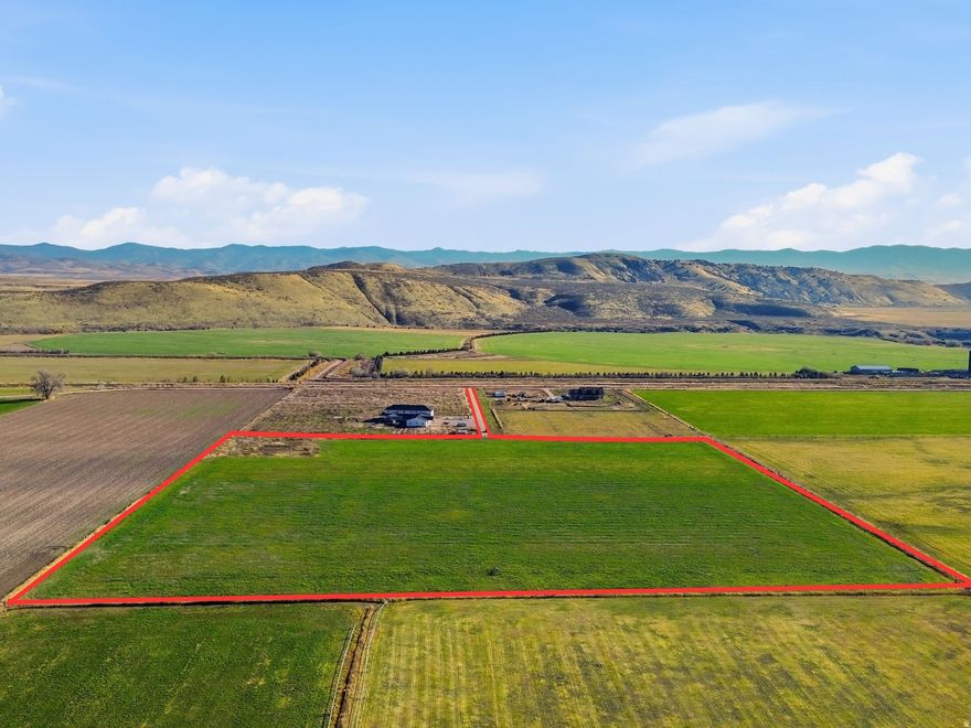 Discover 16.31 acres of agricultural ground in the rural community of Clifton, Idaho. This fully fenced parcel includes pressurized irrigation and 13 shares of Twin Lakes Irrigation Water, offering valuable water resources for farming and land use. The property currently has a verbal farm lease in place that has historically produced 23 cuts annually. With no HOA and an accessible location near 4335 N 4400 W, it's a great opportunity for buyers seeking usable farm ground in a peaceful small-town setting. There is potential for residential development, though buyers must contact Franklin County and local governing entities to verify any subdivision or rezoning possibilities. Culinary water, power, gas, and sewer services are not connected; buyer to verify availability and all required installations. Buyer to verify all information. Address is approximate. It is NOT the land that either home sits on. Road to parcel is between both homes and runs to the west . The sign is in front of the lane going back to the parcel that's for sale.