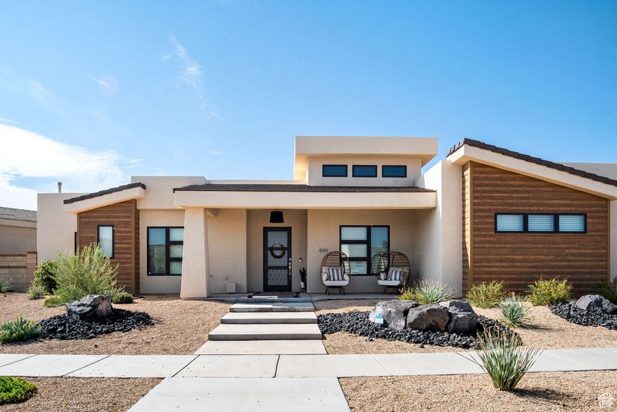 Built by one of the best in the industry. Superior construction with custom finishing from top to bottom.  This open floor plan features a great room, kitchen area with extra high ceilings, a grand primary suite, an additional primary bedroom with its own private shower, a front flex room (with window and large closet) which can easily be used as a 5th bedroom, an oversized covered patio wired for TV and plumbed for a gas BBQ. Two furnaces, two a/c's, and two water heaters make this home efficient and comfortable. Other features include high-end appliances, quality cabinets, quartz countertops, custom tile flooring and backsplashes, walk-in showers, large windows, a professionally painted three-car garage with a sink, and an EV charging outlet. This stunning home feels and looks brand new. It has been used as a second home with minimal usage. Professionally designed and decorated. Two 90% plus efficient HVAC systems, 2x6 exterior walls, low-E windows,  and insulated garage doors. This home is conveniently located in the subdivision on a quiet street, and it's only a few minutes' walk to the Desert Color Amenities. All furnishings can be purchased separately, and this home can be move-in ready with a turn-key transition, including five TVs, towels, bedding, silverware, dcor, and more.