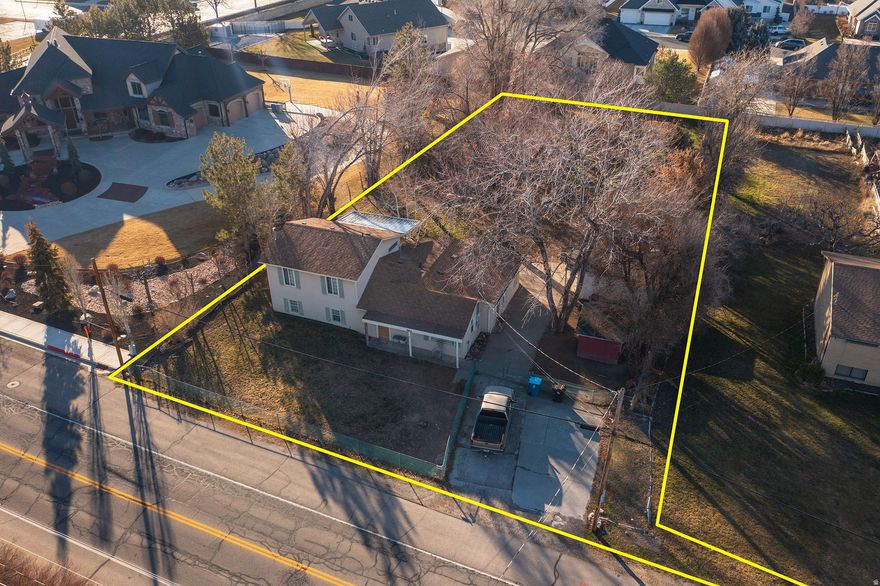 Rare opportunity to purchase a .68-acre property in Lindon, Utah, offered either as a residence or as a build-ready land opportunity. The property is currently improved with a home and includes approved building and demolition permits with the City, providing a significant head start for buyers planning new construction. This flat, narrow, and deep lot offers excellent usability and versatility. The property features mature shade trees, fruit trees, and a generous yard, along with a rear field well-suited for animals or hobby farming. Animal rights are included, making this an increasingly rare offering in such a desirable area.