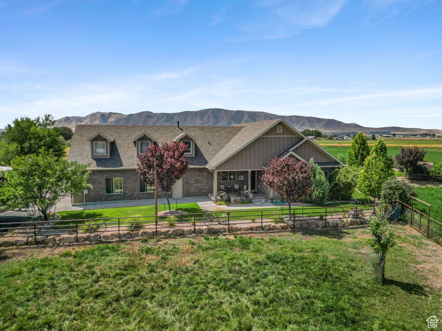 *SELLER FINANCING NOW AVAILABLE! Great terms! Call to talk details.* Discover a rare opportunity to own a breathtaking 9.76-acre estate in Spanish Fork, perfectly designed for both luxury living and horse enthusiasts. This custom-built one-of-a-kind home offers unparalleled craftsmanship, featuring an oversized 3-car garage with a convenient dog wash station. Enjoy the flexibility of gas or electric connections for both the stove and dryer. Equipped for the ultimate horse property, the estate includes a horse barn with four spacious 12'x16' horse stalls and an attached ADU, ideal for guests or rental income. The riding arena can easily be converted into a team roping pen, catering to any level of activity. Cement ditches ensure efficient irrigation, while drill pipe fencing adds security and durability throughout the property.  For those needing ample workspace, the fully insulated 72'x48' detached shop with a gas heater is a dream come true, providing endless possibilities for hobbies, storage, or business ventures. Come and see for yourself the panoramic mountain views and privacy this home has to offer. Water shares are with Strawberry Water and South Field Irrigation, additional shares are leased through C.U.P water (Central Water) and can be taken over by the new owners.