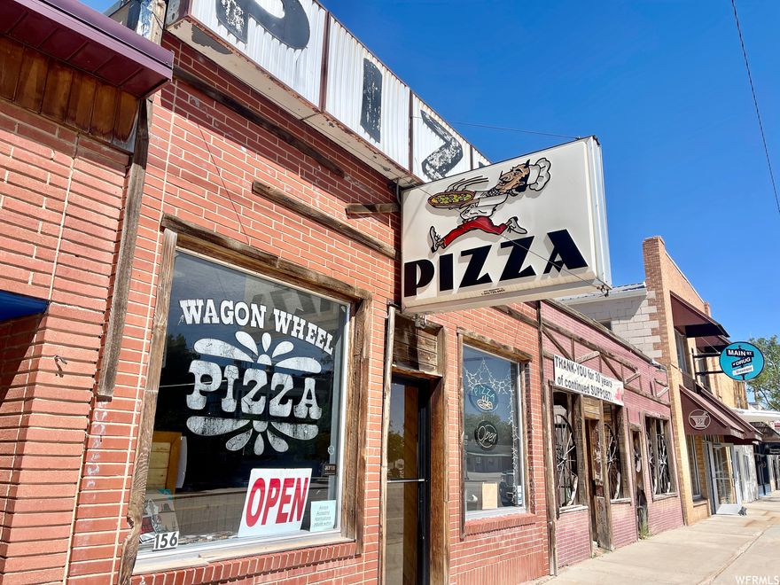 Presenting Wagon Wheel Pizza, a beloved local eatery and a family owned business that has supported the current owner for 35+ years! This commercial building and successful business package is TURNKEY and includes prime real estate along main street, offering excellent visibility and accessibility to locals and tourists visiting the 3 National Parks nearby. It is the original building and has been very well maintained throughout the years. Included on the property is an outdoor area, providing endless possibilities for outdoor dining, hosting events, or even building another commercial space with living quarters above. With a stellar 35+ year reputation, it has become an integral part of the community. The loyal customer base, built over decades of dedication, ensures a steady stream of customers year-round. From all of the kitchen equipment to the treasured recipes cherished by patrons, you'll have everything required to maintain the high standard of quality that Wagon Wheel Pizza is known for and the prime real estate to fulfill your business passions!