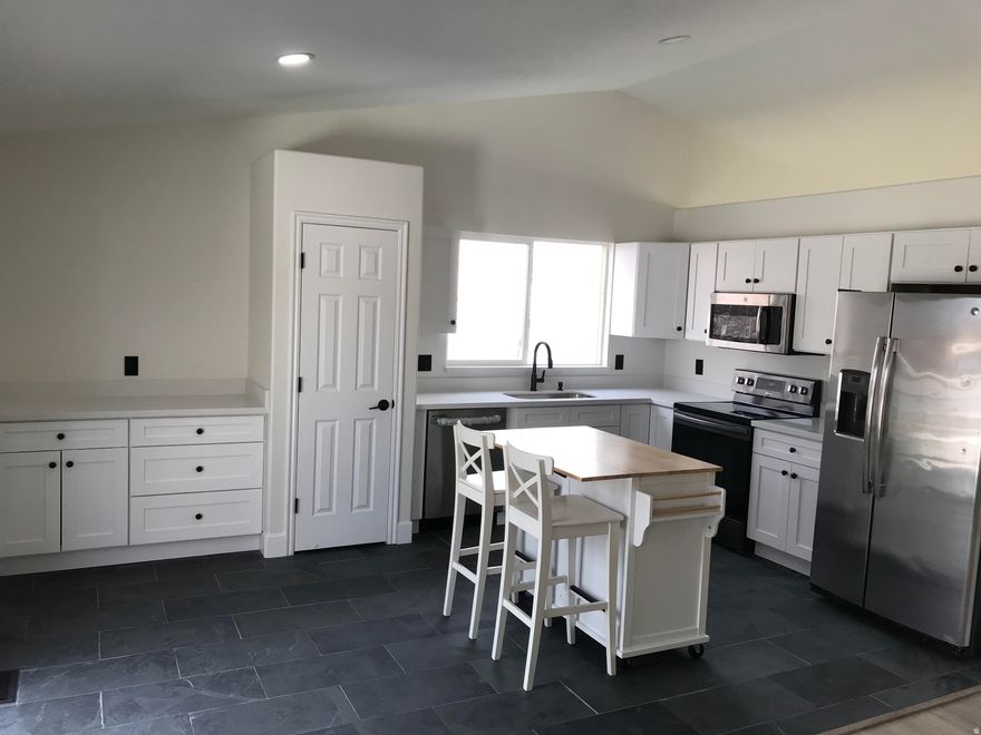 This is the lowest price per sq foot on the MLS in West Jordan under 2400 sq feet with 2 car garage and finished basement. CHECK IT OUT! Attention picky buyer!! This floor plan has the Great Room off the kitchen instead of the 3rd bedroom on the main level.. Just completed a remodel of this home including new kitchen and flooring by seller! Cabinets and White quartz counter tops have been installed in this new kitchen.. Nearly All new flooring . New cabinets are white, craftsman style and are not cheap box store brand. Freshly painted 95% of the interior. New dishwasher! Just installed NEW slate stone floors in kitchen and bath plus new LVP in Master bedroom plus carpet throughout basement. The basement has a space heater type gas fireplace. RV parking for all your fun stuff. Seller Finance possibility with a low down payment. Seller is including a new kitchen island cart