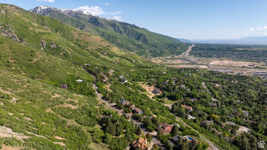 Set high in the wooded hills of the Eastwood community and tucked against the foothills, this generous 0.88-acre lot offers the perfect canvas for your dream home. With wide-open views stretching across Ogden to the west and stunning mountain vistas to the south, few homesites rival this one in beauty or setting. The land is dotted with mature trees and native foliage, creating a seamless connection to the surrounding landscape. Despite its peaceful, mountainside feel, this property is just minutes from major routes-including Hwy 89, I-15, and I-84-making it easy to access Hill Air Force Base, Weber State University, Snowbasin Resort, hospitals, top-rated schools, and Ogden's expansive trail system. Some tasteful landscaping and rock work are already in place, adding to the charm of this amazing lot. A rare opportunity to enjoy space, scenery, and convenience-all in one. Buyer to verify all property details, boundaries, and documentation.