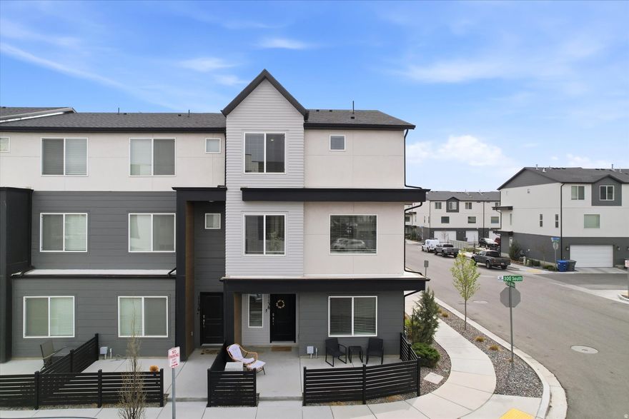 OPEN HOUSE THIS SATURDAY 3/28 12pm to 2pm. This modern end-unit highly updated townhome offers a thoughtfully designed multi-level layout with added privacy and abundant natural light from the extra-large end-unit windows, creating a bright and inviting space that lives like a single-family home but with the price point and convenience of townhouse living.  The entry level welcomes you with a versatile flex room or bedroom paired with a full bathroom, ideal for guests, a private home office, fitness room, or additional living space. Upstairs, the main living level features an open-concept design with 9-foot ceilings and expansive windows that fill the home with natural light. The kitchen is finished with stainless steel appliances, gas range, quartz countertops, durable laminate flooring, and a deep pantry, with the layout flowing seamlessly through the kitchen, dining, and family room-ideal for both everyday living and entertaining. High-quality finishes and appliances are found throughout the home. 4K Family Room TV, washer, dryer, pedestals, refrigerator, and water softener are ALL included, and most furniture is negotiable.  The top floor features three bedrooms, including the primary suite with a private bathroom and walk-in closet. The additional bedrooms are generously sized and well suited for a variety of uses including bedrooms, guest rooms, office space, or hobbies, with another full bathroom and conveniently located laundry closet on the same level.  Additional highlights include smart home features such as a video doorbell, MyQ smart garage, and Safe Haven hub. The home also features an extra deep two-car garage, additional storage, and a large crawl space unfinished underground storage area beneath the home that is perfect for seasonal items, outdoor gear, and extra storage needs.  Residents enjoy access to community amenities including a clubhouse and pool, along with a prime location just south of Pioneer Crossing that offers excellent commuting access while maintaining a welcoming neighborhood feel. Short term rentals are allowed at this property! All short term rentals must comply with city and state regulations including obtaining any required permits/licenses. Sellers are requesting delayed possession or leaseback until early to mid-June. Square footage is based on county records and is provided as a courtesy to buyer. Buyer to verify all information.