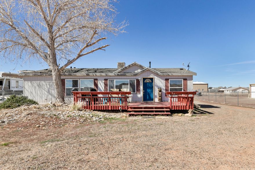 Welcome to your gateway to adventure in Southern Utah. Situated on  acre in the quiet community of Big Water, this unique property offers a rare blend of residential comfort, massive storage space, and unbeatable proximity to some of the most iconic landscapes in the Southwest. The ~1,200 sq ft manufactured home provides a comfortable basecamp, while the real standout feature is the 30' x 40' shop-perfect for storing boats, side-by-sides, dirt bikes, tools, or building out the ultimate desert workshop. With room for all your toys and gear, this property is built for those who love to explore. Location is everything here. You're just 12 minutes from Lone Rock Beach at Lake Powell, one of the most unique lakeside destinations in the country where you can drive right onto the sand and launch into endless water recreation. Just 10 minutes away sits the world-renowned Amangiri resort, one of the most exclusive luxury destinations in Utah, drawing travelers from around the globe. Another rare advantage: this property is one of the few grandfathered residential properties in the area, as the surrounding community has since transitioned to commercial zoning-creating potential flexibility and long-term value that is increasingly hard to find. Outdoor enthusiasts will feel right at home. The surrounding desert is a playground for side-by-side, dirt bike, and mountain bike riders, with countless trails stretching through breathtaking Mars like terrain. In fact, many well-known MTB and dirt bike videos have been filmed in this exact area, thanks to the dramatic landscapes and endless terrain. Whether you're looking for a desert getaway, adventure basecamp, workshop property, or a unique opportunity near Lake Powell, 200 Ethan Allen offers space, freedom, and access to some of the most stunning scenery in Utah. Adventure, storage, and opportunity-all just minutes from Lake Powell.