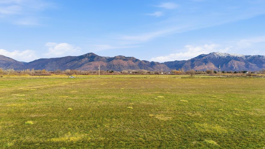 Rare opportunity to acquire a versatile 0.92-acre parcel in an established area with existing utilities nearby. Flat, usable land with excellent potential for residential use, future build, or long-term investment. Property features open space, mature surroundings, and convenient access.  Located in the desirable community of Marriott-Slaterville, known for its open space and limited build-out, offering a quiet, rural feel while remaining approximately 15 minutes from Downtown Ogden and close to local amenities. Ideal for those seeking space, flexibility, and future potential in a sought-after location. One water share is included with sale.