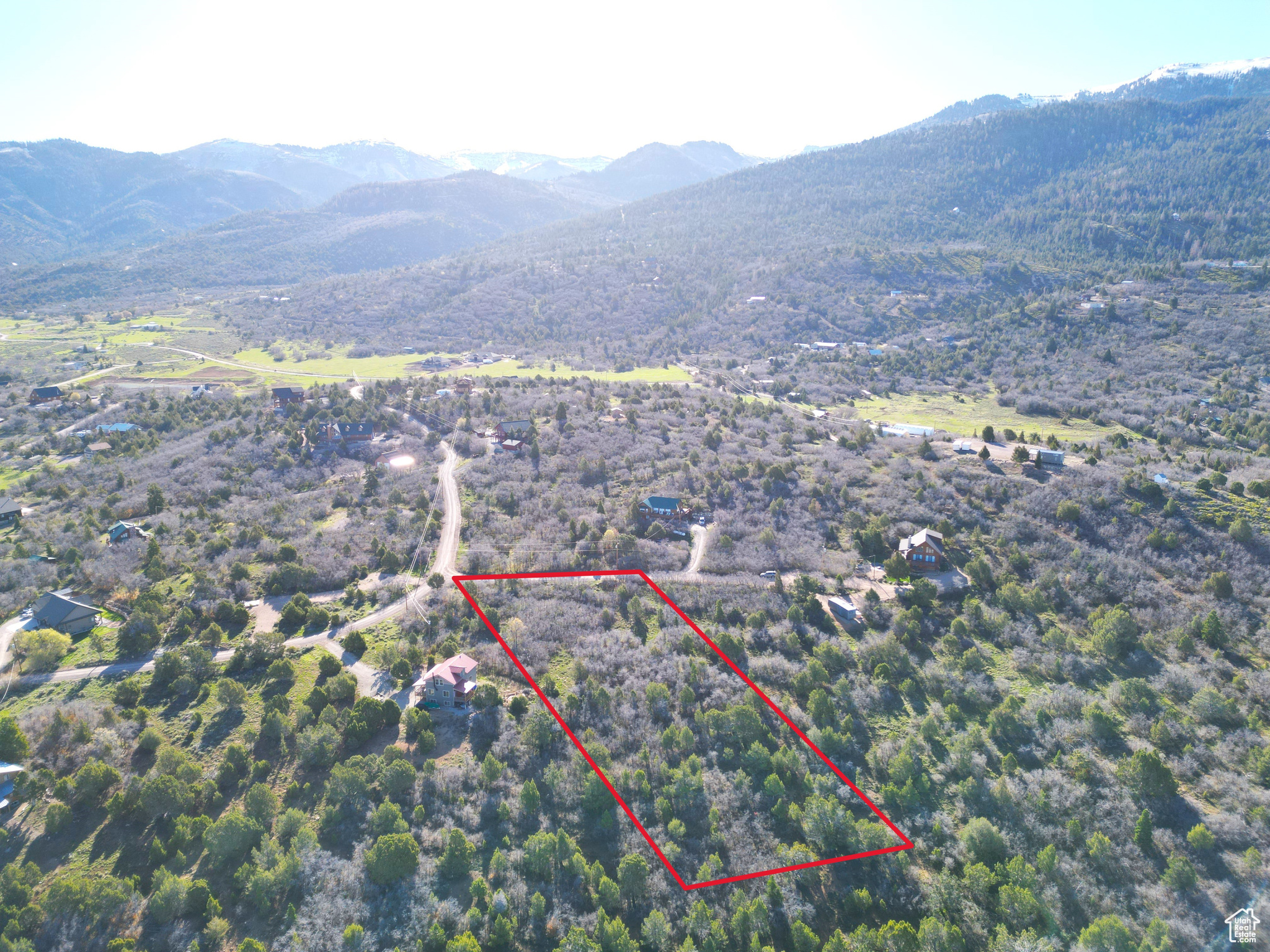 Welcome to Whispering Pines III-a year-round, gated mountain community featuring a private recreational pond, trails, and breathtaking valley views. This secluded 1.17-acre lot sits on a cul-de-sac at the edge of the community, offering unobstructed mountain and valley vistas with mature foliage scattered throughout for privacy and beauty. Community amenities include large fishing pond-ideal for kayaking, swimming or paddle boarding. Also, disc golf, trails, and annual road and gate maintenance by the HOA, ensuring easy year-round access. Culinary water is already stubbed and ready for connection. Power is available at the frontage, gas is propane, sewer is septic, and hard-wired internet is available. Located approximately 7 miles southeast of Mt. Pleasant and just 60 minutes from Spanish Fork, this property is ideal for a primary mountain residence or a peaceful weekend retreat. The gently sloped lot borders private land to the west, enhancing both privacy and views. Please note: Septic installation and propane setup will be required. All information within is provided as a courtesy only. Buyer and buyer's agent are advised to complete their own due diligence and independent measurements. Boundary and lot lines shown are approximate.