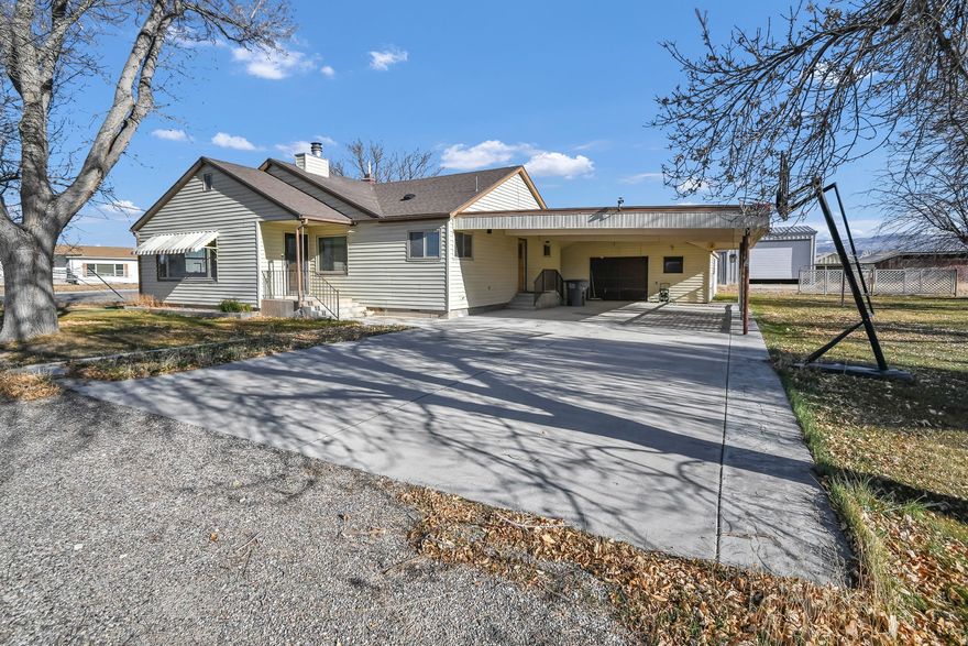 This well-built property offers endless potential-enjoy it as a spacious home with land for animals, or, if you own Centerfield water shares, explore the opportunity to subdivide the back portion and build. The home offers 3 bedrooms with the potential for a 4th thanks to a finished basement, along with abundant storage throughout. Large outbuildings and a spacious garage with a dedicated workshop provide plenty of room for projects and equipment. Inside, the updated kitchen features granite countertops, stainless steel appliances, a double oven, and an electric cooktop, while the living room and dining area are highlighted by a cool retro fireplace that adds timeless character. The property includes one water share currently servicing the home, and additional water would be required for the back portion of the property, along with mature fruit trees and a full sprinkling system that complete this versatile property.  Square footage figures are provided as a courtesy estimate only and were obtained from county .  Buyer is advised to obtain an independent measurement.