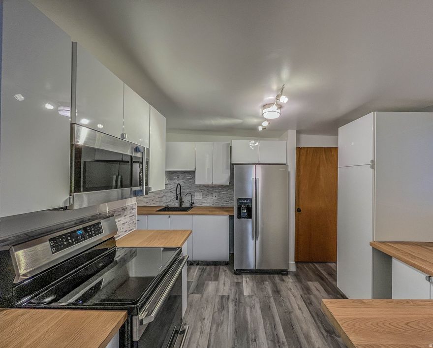 Gorgeous mountain views surround this charming Tooele home! The updated kitchen features sleek stainless steel appliances and modern finishes. The spacious owner's bedroom includes a private half bath with room to add a shower for a future upgrade. An unfinished basement with a fireplace offers incredible potential for additional living space or customization. Enjoy the large, fully fenced yard-perfect for entertaining, gardening, or relaxing outdoors. Buyer to verify all information.