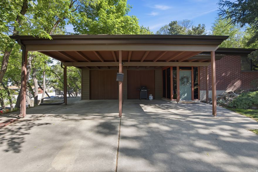 Tucked away in the highly desirable Holladay Hills neighborhood, this charming 3-bedroom, 2-bath home offers the perfect blend of privacy, character, and timeless design. Set on a secluded lot with mature landscaping, the yard provides a peaceful retreat-ideal for relaxing, entertaining, or simply enjoying the natural surroundings.  Inside, you'll find a warm and inviting layout with a distinct mid-century vibe, featuring clean lines, large windows, and an effortless connection between indoor and outdoor living. The walk-out basement adds versatility and functionality, offering additional living space with direct access to the backyard-perfect for guests, a home office, or a cozy secondary living area.  The home also includes a convenient 2-car carport and thoughtful touches throughout that highlight its unique style and livability. Located just minutes from parks, hiking trails, shopping, and dining, this Holladay Hills gem delivers both tranquility and accessibility.  Don't miss the opportunity to own a home with character in one of Holladay's most sought-after neighborhoods.  Square footage figures are provided as a courtesy estimate only and were obtained from  County records.  Buyer is advised to obtain an independent measurement.