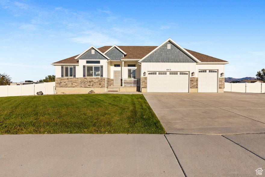 Tranquil,  Nearly Brand New Half Acre Grantsville Home With Stunning Upgrades! Separate Basement Entrance and 3 Car Garage.  Sprawling Yard in Front & Back with Additional RV Side Parking, Fully Fenced, Natural Gas Fire Pit in Backyard.   Room For Garden and Loads of other Fun Backyard Features.  Walk into a  Grand Foyer with Dedicated Office/Living room. Upgraded Solid Flooring and Impressive Vaulted Ceilings.  Custom Wainscotting on Family Room wall with a cozy Gas Corner Fireplace.  Easy open concept with Lovely Kitchen with Staggered Wood Cabinets, Stainless Steel Appliances, Granite Counter, Wall Pantry and Center Island. Plantation Shutters throughout.  NEW Carpet throughout. Main Level living with Primary Bedroom and Laundry on main level.  Primary Bedroom has attached En suite bathroom with Dual Sink Vanity, Separate Step in Shower and Soaking tub.  Room to Grow in the over 1800 Sq Foot Basement. Large Cold Storage Room.   One Full Bathroom has been finished in Basement.  Dedicated Exterior Entrance.