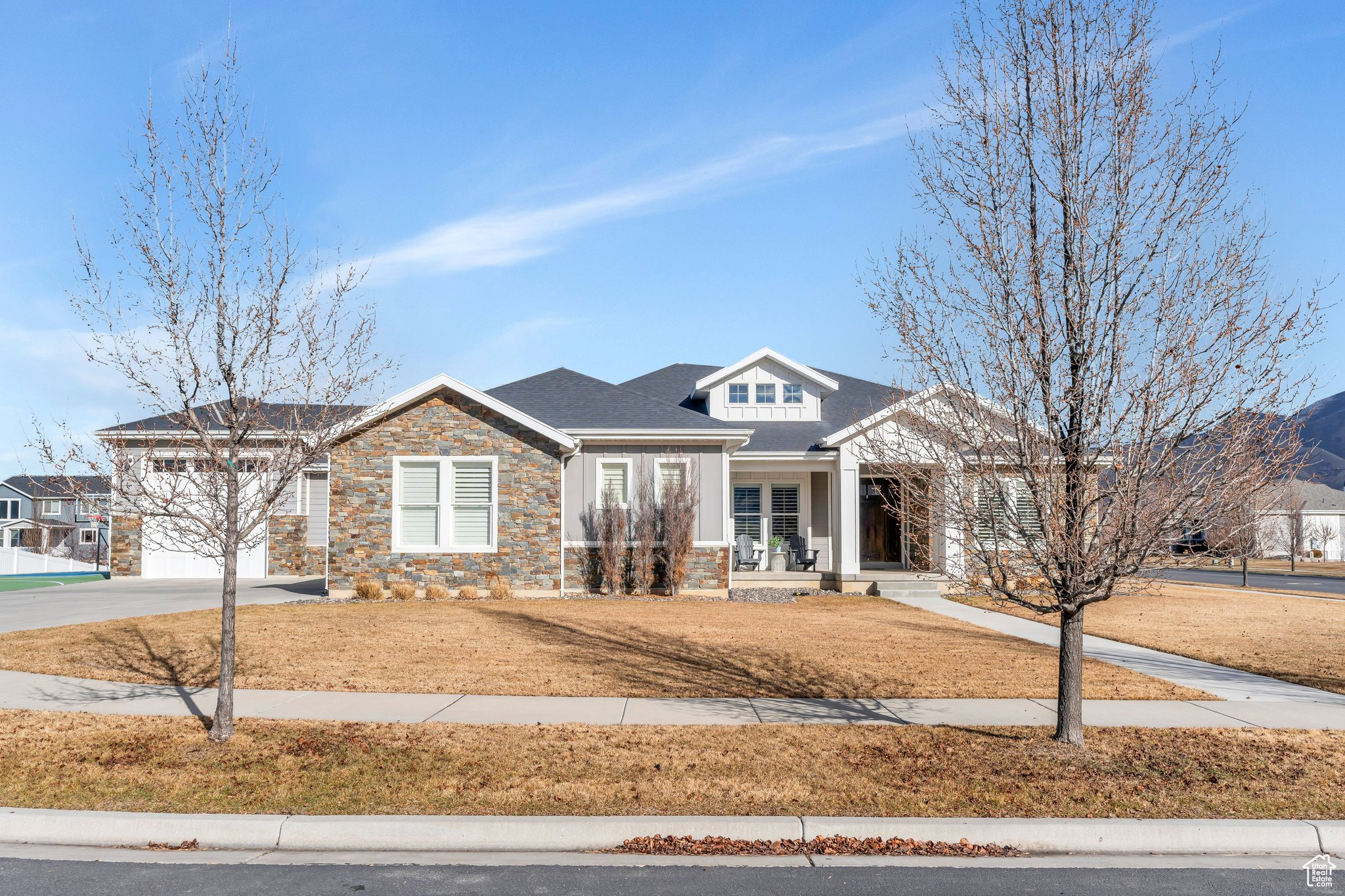 This beautiful custom-built home is a rare find! It is located in a quiet culdesac in a very desirable neighborhood in Mapleton. Mountain views are spectacular.  It includes a full functioning sport court, putting green and an Iron Mike batting cage for some backyard fun. The home features a spacious four-car garage with a RV/high lift garage, providing plenty of space for all your vehicles and toys. It also includes a separate storage garage for lawn equipment.  A great home for entertaining with the open-concept living and dining areas.  Step outside to a large covered deck and a lower patio, both perfect for enjoying the scenic beauty that surrounds you. The master suite features a walk-in closet with its own separate tub and spacious walk-in shower. The lower level offers a versatile walkout basement with a  kitchenette that could easily be made into a separate kitchen, making it a potential rental space with its own private entrance.