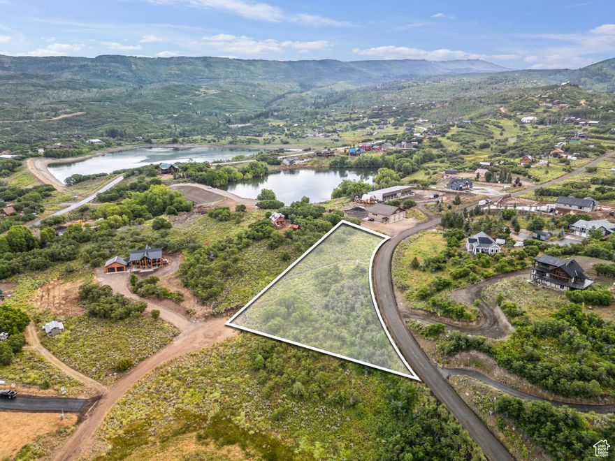 ARCHITECTURAL PLANS INCLUDED. Scenic Timberlakes Lot  Views, Access, Lifestyle  Discover the perfect homesite in Timberlakes, a gated mountain community just minutes from Heber City and Park City. This incredible lot offers unbeatable views-overlooking a peaceful pond and backing to the majestic Uinta Mountains. With a gentle slope ideal for a walk-out basement.   The lot sits on a plow route for reliable winter access and feels wonderfully remote, yet neighbors and amenities are close by.  In winter, the nearby pond becomes a neighborhood ice rink. ATV, UTV, and snowmobile trails connect directly from Timberlakes to miles of backcountry. Driveway access is possible from both the top and the cul-de-sac, making building easy.  You're minutes from world-class fly fishing on the Provo River, three pristine reservoirs, top-tier golf, and nine ski resorts-including Deer Valley, Sundance, and the new Mayflower resort. Heber offers a small-town feel but is one of the fastest-growing areas in the U.S., with a new high school on the way.  Only ~60 miles from Salt Lake City International and just minutes to Heber Valley Airport (runway supports private jets), this property is more than a lot-it's a gateway to a year-round lifestyle.