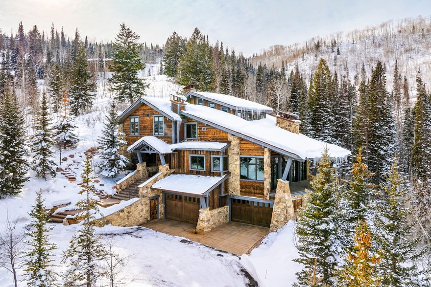 Discover luxurious ski resort living at this private mountain estate, nestled in the prestigious, gated, ski-in/ski-out community of The Colony at White Pine Canyon. Offering unparalleled ski access to Park City Mountain Resort from this prime location-just 1.6 miles from the gatehouse-this residence blends convenience and exclusivity. Nestled among the pines and aspens, ski right out your door to fresh powder onto Sanctuary run that leads to the main artery of the resort via Tombstone Lift. Tombstone Lift takes you to a central launch point for world-class ski trails, while Timberline Lift offers access to Iron Mountain Trails and the Park City gondola. This home features a timeless Mountain Modern style, with grand wood beams and transom windows, all while maintaining a cozy atmosphere and a functional floor plan. The living room flows seamlessly from the gourmet kitchen and dining area and leads out to an expansive wrap-around covered deck with stunning mountain views and outdoor grilling area. This expansive home includes five bedrooms, each ensuite, with an option for a sixth bedroom in the loft area. The dedicated primary bedroom suite with adjoining office, and a spacious walk-through closet with a washer/dryer, offers additional convenience. A custom ski prep room, dry sauna and steam room, ensures you're always ready for the slopes, while a rejuvenating hot tub awaits you outside the ski prep area and ski in location. The lower-level family room, which features a bar, wine cellar, convenient beer tap, and gas fireplace is a lovely entertainment area for friends and family to enjoy. The heated 4-car garage and adjacent mudroom with custom cabinetry provide ample space for vehicles and all your mountain gear. Whether your primary residence or second home, this property presents a rare opportunity to experience the best of The Colony lifestyle, combining superior ski access with a coveted location close to everything Park City has to offer. Located just 15 minutes from Park City's Historic Main Street, where you'll find boutique shopping and fine dining, and only 45 minutes from Salt Lake City International Airport, it's an unparalleled blend of mountain serenity and urban convenience. The Colony at White Pine Canyon is an award-winning, 330-homesite, on-mountain community situated on the slopes of Park City Mountain Resort. Skiing, snowboarding, hiking, and biking trails weave throughout the community, offering year-round recreational opportunities surrounded by trees and in a stunning, private mountain setting.  **The furniture in the property photos was used for staging and is no longer present in the home.