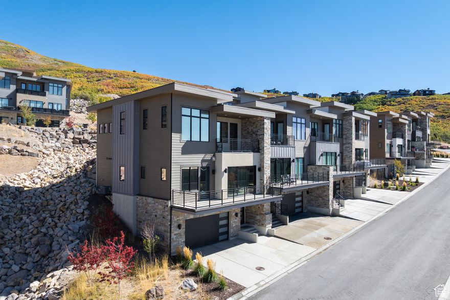 Modern Klaim Townhome with Luxury Upgrades, Smart Comfort & Panoramic Views  Experience modern mountain living in this 3-bedroom Klaim townhome with sweeping views of Deer Valley, Park City, and the Jordanelle Reservoir. Soaring ceilings, automated Hunter Douglas shades, and a chef's kitchen with Thermador appliances set the stage for gatherings. The primary suite offers a steam shower, heated floors, and a custom closet, while balconies prewired for heaters and an epoxy garage with EV prewire add year-round comfort and convenience just minutes from world-class skiing and Main Street.