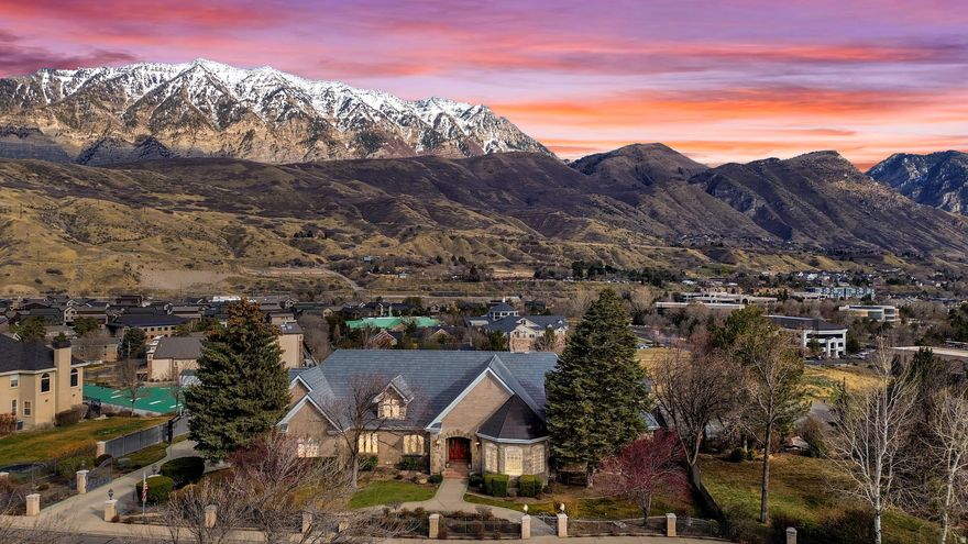 Tucked into the hillside of Bella Vista Heights, this remarkable Orem estate offers over10,000 square feet of thoughtfully designed living space on a private 0.64-acre lot with breathtaking mountain views and open space behind the home.  From the moment you enter, the home impresses with expansive living areas, soaring ceilings, and walls of windows that capture natural light and frame the surrounding scenery. The layout was designed with both entertaining and everyday living in mind, featuring multiple gathering spaces, four fireplaces, and a spacious kitchen with custom cabinetry and beautiful hickory flooring.  The walk-out lower level expands the living possibilities with a second full kitchen, large family room, guest suite, and game room area-perfect for hosting, extended family, or private retreat space.  The primary suite provides a luxurious escape with its own fireplace, spa-style bathroom, and private deck access overlooking the mountains.  Outside, the grounds offer mature landscaping, multiple patios and decks, RV parking with hookups, and a heated driveway and walkway for year-round ease.  Additional features include elevator access to all levels, new Lennox HVAC systems, tankless water heater, water softener, energy-efficient upgrades, and an oversized three-car garage with generous storage.  Located in a quiet cul-de-sac just minutes from shopping, dining, schools, and outdoor recreation, this home combines luxury, privacy, and convenience in one exceptional property. All details provided as a courtesy only, buyer encouraged to verify all information. Square feet obtained through a prior appraisal.