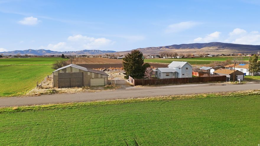Looking for a shop property with room to build? This 0.50-acre parcel on the outskirts of Tremonton features an approximately 2,500 sq ft shop, making it a great opportunity to build your future home while already having valuable shop space in place, or simply utilize the existing shop for your needs. The property includes an electric gate for added security and convenience, and the shop is connected to power. The shop is being sold as-is. Also included is  share of Bear River Canal irrigation water, adding value and utility to the property. The neighboring home on an additional 0.49 acres is also available and listed separately, and could potentially be purchased together if a buyer is interested in combining the properties. Great opportunity for anyone looking for shop space, land, and flexibility in a convenient Tremonton location. Buyer to verify all information.